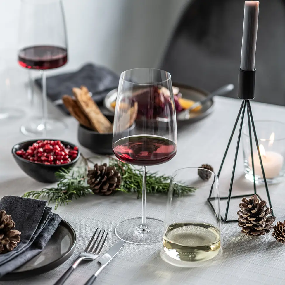 Modern red wine glass on a winter-set table
